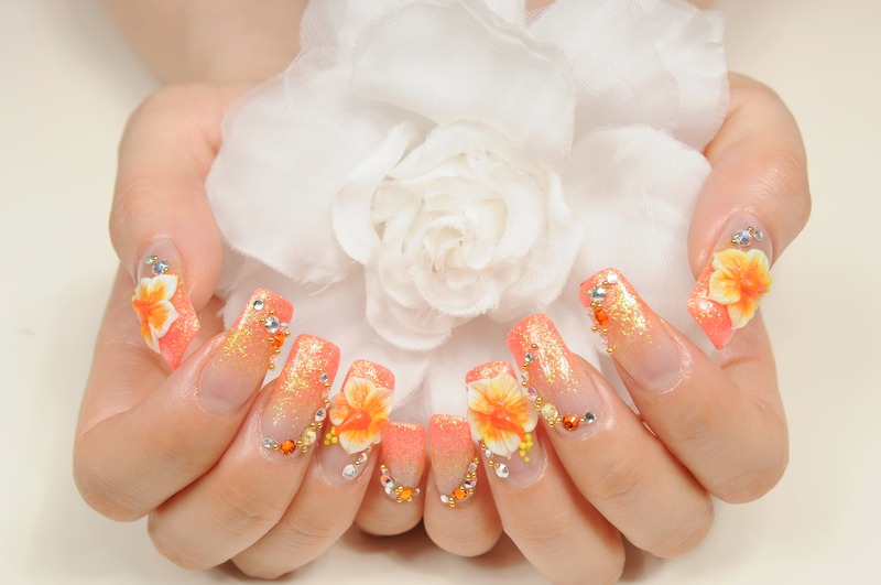 Beautiful coral and orange floral nail art design